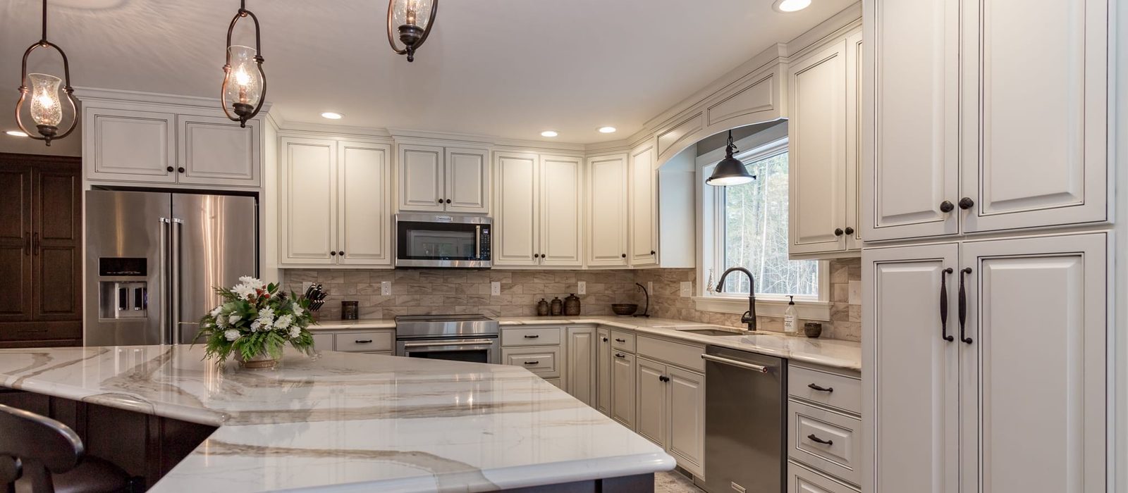 Custom kitchen by Haven Renovations — wood island with stone top