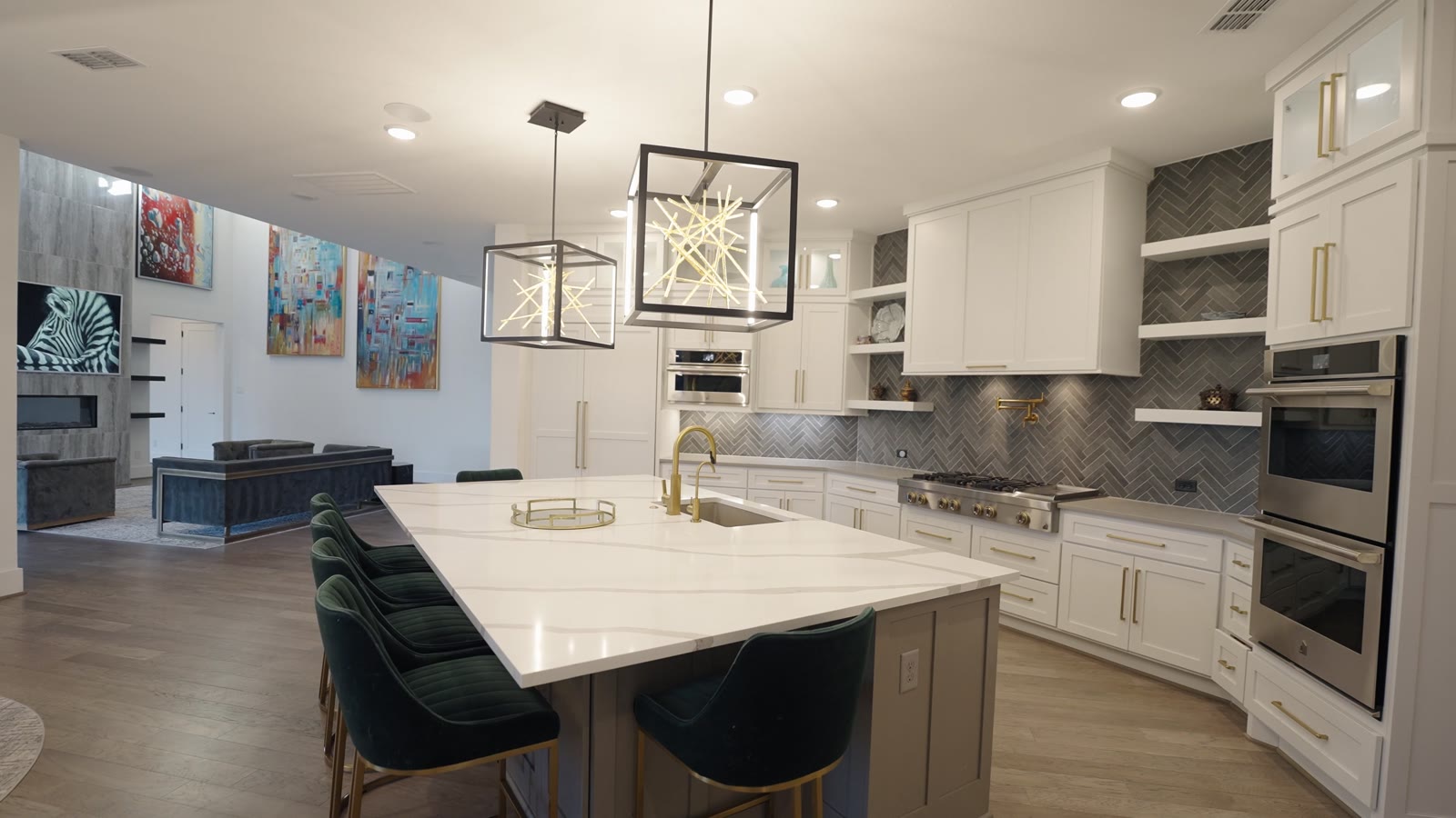 Custom kitchen by Haven Renovations — quartz waterfall island with herringbone tile and a professional range