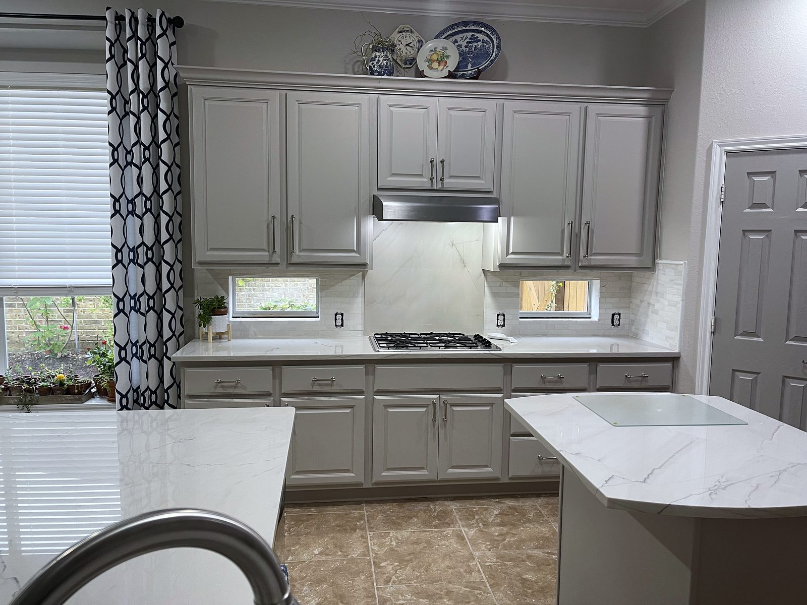 Custom kitchen by Haven Renovations — grey cabinetry, slab backsplash