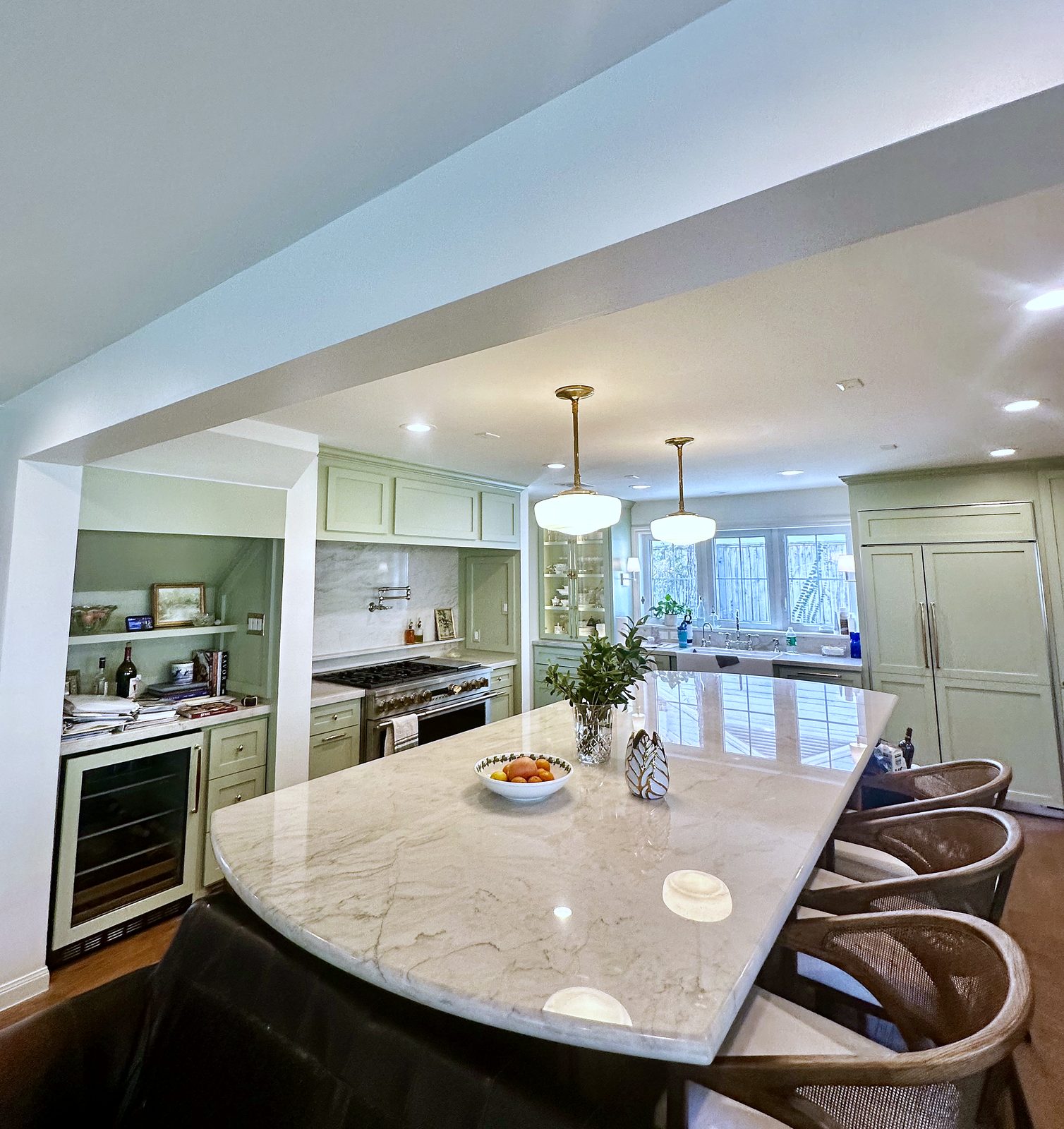 Custom kitchen by Haven Renovations — schoolhouse pendants, marble